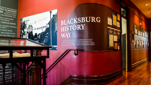 This is a picture of the beginning of our Blacksburg history timeline. On the wall, you can see an old black and white photo of Blacksburg's main street and the text "Blacksburg History Way" beside it.